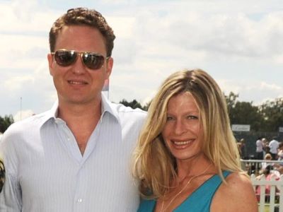 Charlotte Brosnan is wearing a blue dress and Alex Smith is wearing a white shirt and shades.